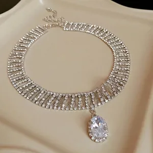 Elegant silver-toned rhinestone choker necklace featuring a large oval zircon drop pendant