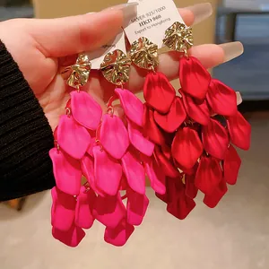 Close-up of matte petal tassel earrings with hammered gold studs and S925 silver needles