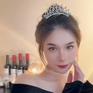 Elegant pearl and rhinestone tiara worn by a model for weddings or birthday parties.