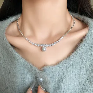 Elegant French style necklace featuring faux pearls and a zircon pendant on model neck.