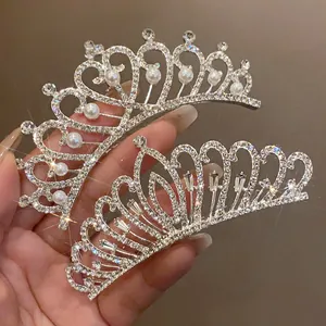 Close-up of sparkling rhinestone and pearl bridal tiaras showing intricate crown designs
