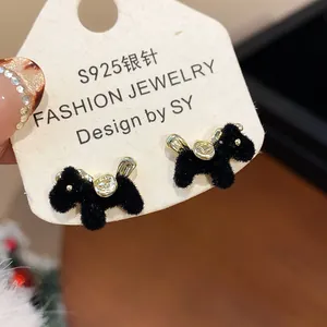 Close-up of black flocked horse stud earrings with S925 silver needles on a card.