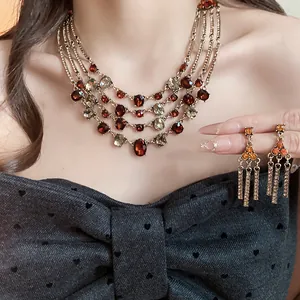 Elegant vintage multi-layer necklace and earrings set with red and smoky oval crystals