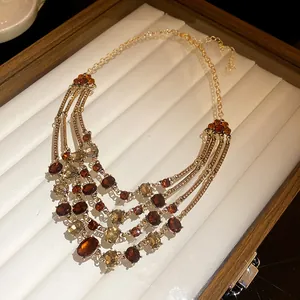Close-up detail of a vintage multi-strand necklace featuring elegant amber oval stones