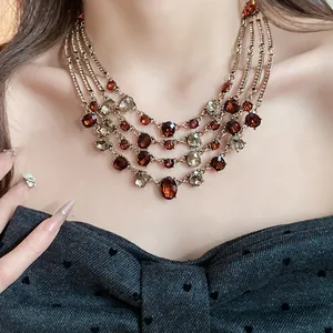 Close-up of vintage multi-layer necklace with amber and crystal oval stones