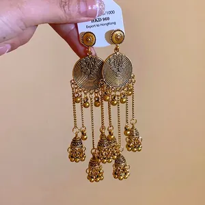 Handcrafted ethnic style round tassel earrings with copper bells and retro golden finish