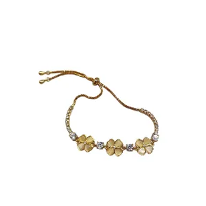 Elegant gold bracelet with cat-eye flower charms and zircon stones, adjustable design