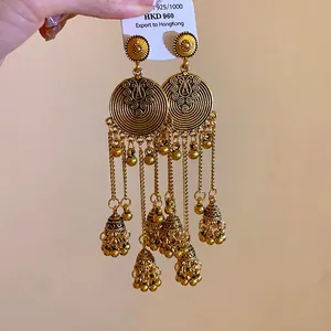 Vintage ethnic style gold tassel earrings with spiral discs and bell charms jewelry