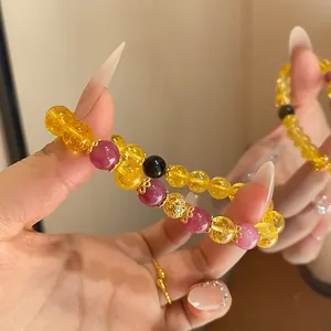 Detailed close-up of a new Chinese style beaded bracelet with yellow and purple gemstones