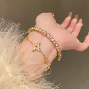 Macro view of luxury gold-plated zircon flower bracelet and matching tennis bangle