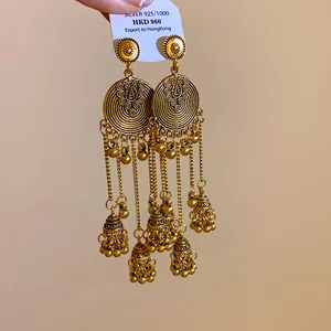 Detail of ethnic Jhumka bell tassel earrings with vintage bronze finish and silver needle.