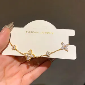 Exquisite detail of a gold-plated flower bracelet with sparkling zircons on jewelry card