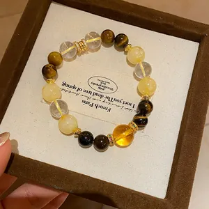 Macro view of a natural tiger eye and clear quartz stone beaded bracelet in a gift box