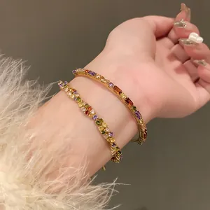 Detailed shot of sparkling multi-colored zircon bangle and bracelet set in gold finish