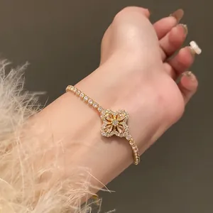 Detailed close-up view of an elegant gold zircon flower bracelet worn on a wrist