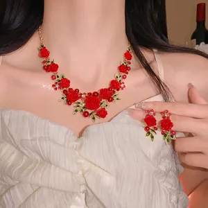 Elegant rose flower and leaf necklace set with pearls and rhinestones on a female model.