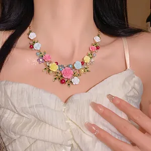 Elegant pastoral floral necklace with rhinestones and pearls worn by an Asian model
