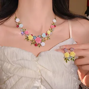 Close-up view of a sweet floral necklace and matching earrings on an Asian model.
