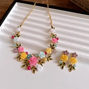 Detail view of colorful floral necklace set with resin roses and sparkling rhinestones