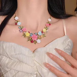 Detailed view of sweet pastoral style necklace featuring colorful roses, leaves, and pearls.