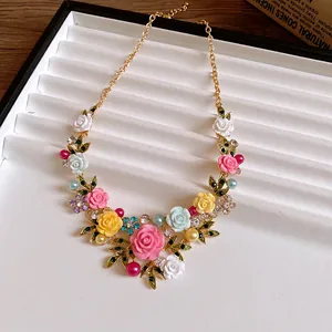 Pastoral rose necklace with colorful flowers, green leaves and sparkly rhinestones.