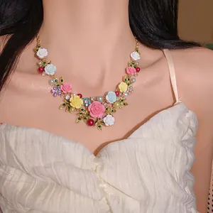 Detailed view of colorful floral bib necklace with rhinestones and resin roses