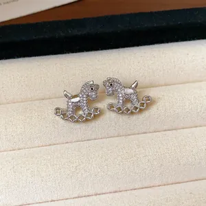 Macro view of silver rocking horse stud earrings featuring sparkling pavé-set zirconia