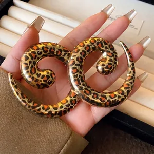 Statement leopard print geometric U-shape choker necklace in a hand-held display