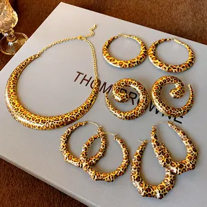 Detailed shot of leopard print geometric collar necklace and various hoop earring set