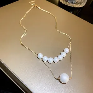 Elegant gold double-layer necklace with mermaid pearls for a minimalist luxury look