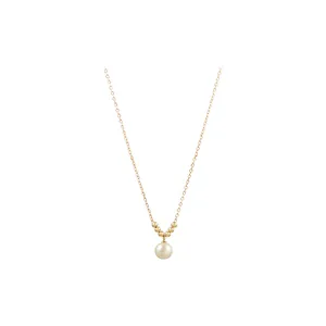 Elegant French style gold chain necklace with a single round pearl pendant.