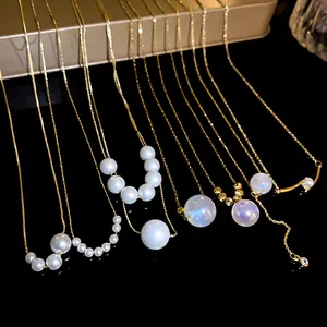 Close-up detail showing various French mermaid iridescent pearl necklaces with gold chain