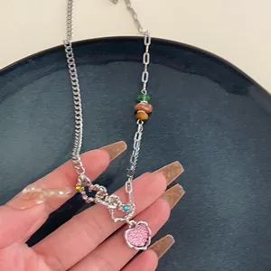 Nahaufnahme einer Y2K Silber Herz Halskette mit rosa Glitzer und bunten Perlen