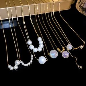 Close-up detail of French mermaid pearl necklaces featuring elegant golden chains