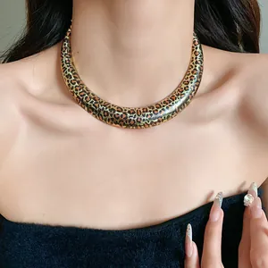 Detailed view of a bold U-shaped leopard print choker necklace worn by a model