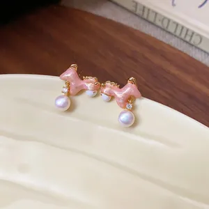 Pink enamel horse dangle earrings with pearls and cubic zirconia in vintage style.