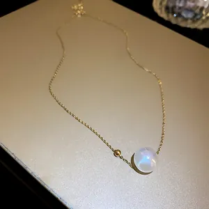 Close-up of mermaid pearl necklace with gold chain and delicate bead detail.