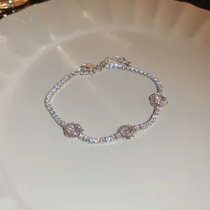 Elegant silver tennis bracelet featuring sparkling cubic zirconia and flower charms