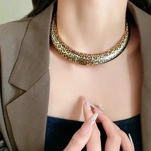 Close-up view of a stylish U-shaped leopard print choker necklace worn by a female model.