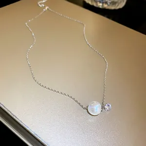 Close-up of elegant French style iridescent pearl necklace with a small sparkling cubic zirconia