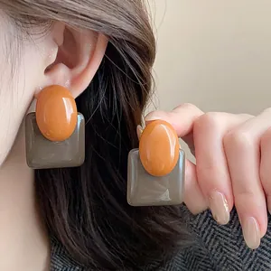 Close-up of French vintage color-block resin earrings with oval and square elements