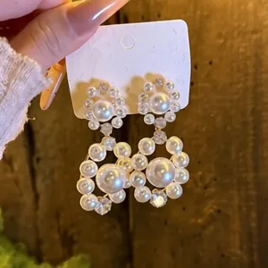 Elegant Korean style dangling earrings featuring pearls and zircons for a chic look.