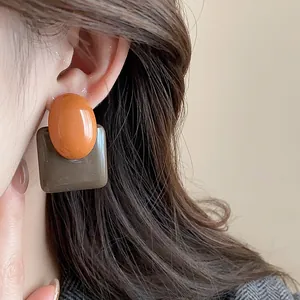 Detailed view of vintage color-block resin earrings with square and oval geometric shapes