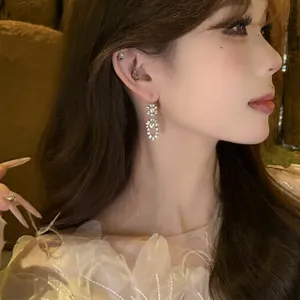Elegant zircon and pearl drop earrings shown on model for a refined, luxurious look.