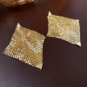 Close-up of elegant gold-toned metal mesh rhombus earrings with triangular accents