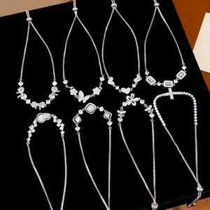 Elegant Korean style zircon bracelets with butterfly and flower charms on black velvet.