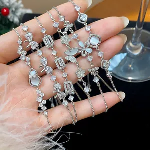 Close-up of silver-toned cubic zirconia bracelets featuring butterfly and floral charms