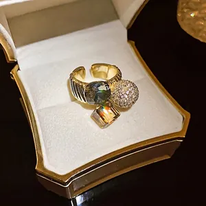 Elegant gold-plated open ring featuring geometric faceted stones and pavé zircon ball in box