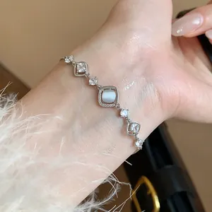 Elegant silver-toned bracelet featuring a luminous cat's eye stone and cubic zirconia