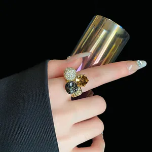Detailed view of luxury gold-plated ring with sparkling crystals and geometric design